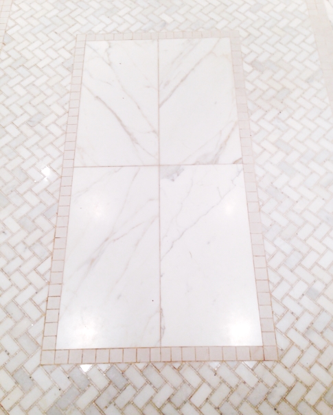 White herringbone floor tiles