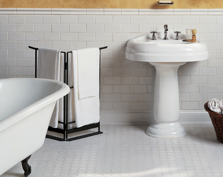 White subway tile on the wall installed with neutral grout and octagon mosaic on the floor